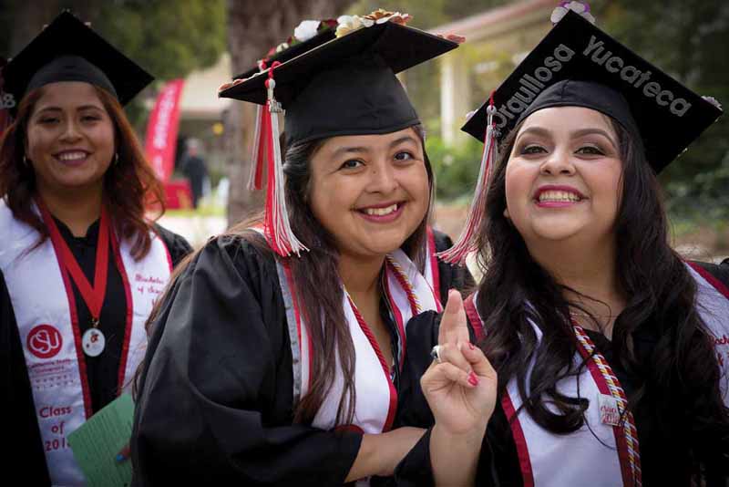 Jennifer Rueda (center) helped other students as a mentor and graduated in May.