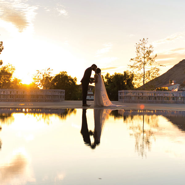 Lauren Gih and Ryan Stokes on their wedding day in front of Broome LIbrary