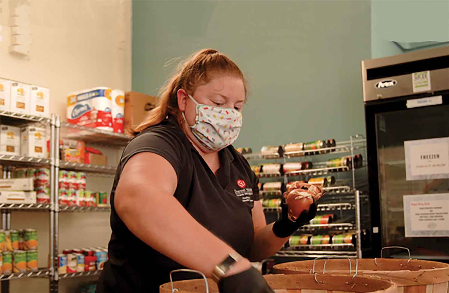 Tanya Yancheson, Coordinator of Campus Life Marketing & Repopulation Initiatives, prepares food bags.