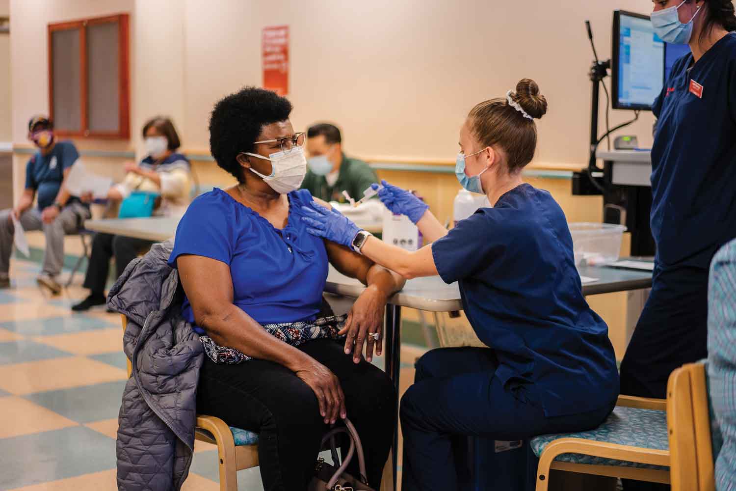 Nursing student Sarah Wilson gives Marie Terzll a vaccine