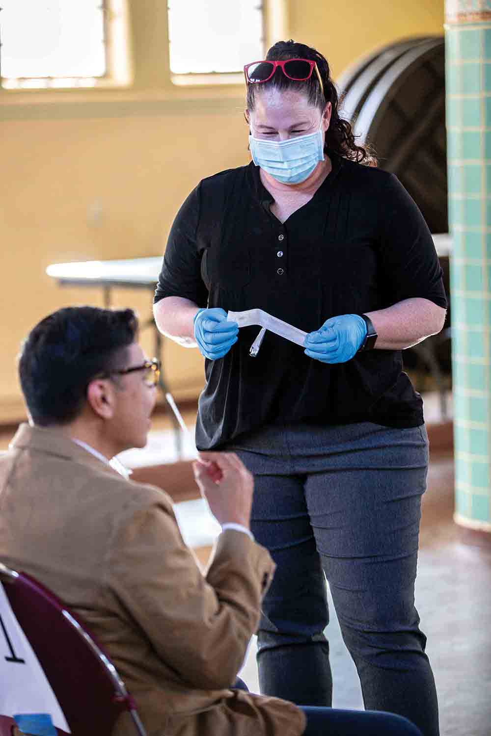 Joyce Spencer conducts a COVID test.