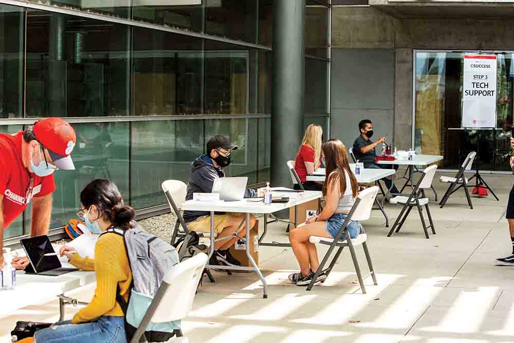 CSUCI’s Information Technology Services helps set up the iPads with the students.