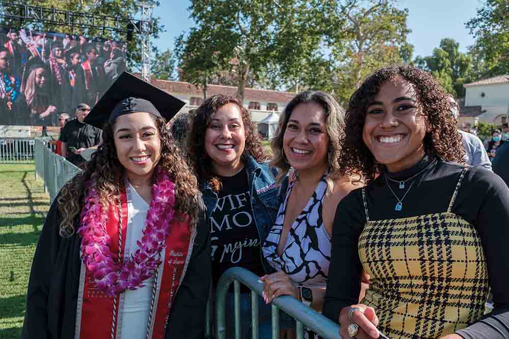 Graduates smile at Commencement