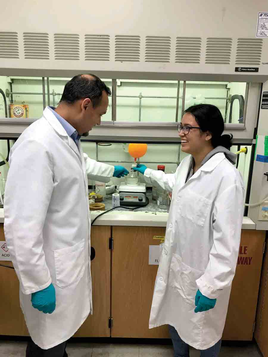 Professor Awad talks with a student