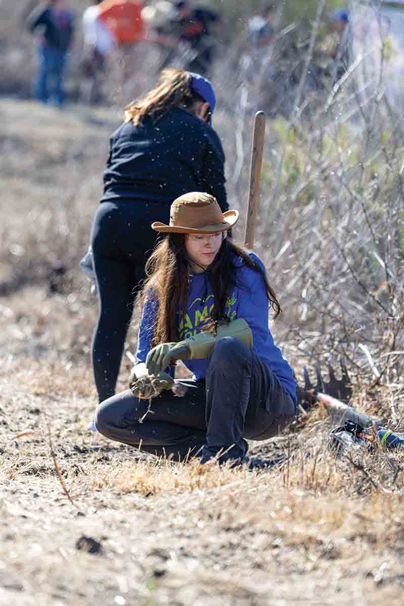 Students, faculty, staff, and alumni volunteered in clearing brush and restoring trails at University Park.