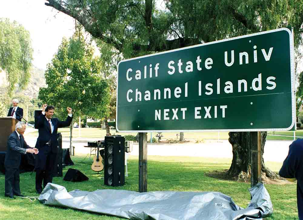 A University highway sign is unveiled in 1999 by then President J. Handel Evans, State Assemblymember Nao Takasugi, and State Senator Jack O’ Connell.