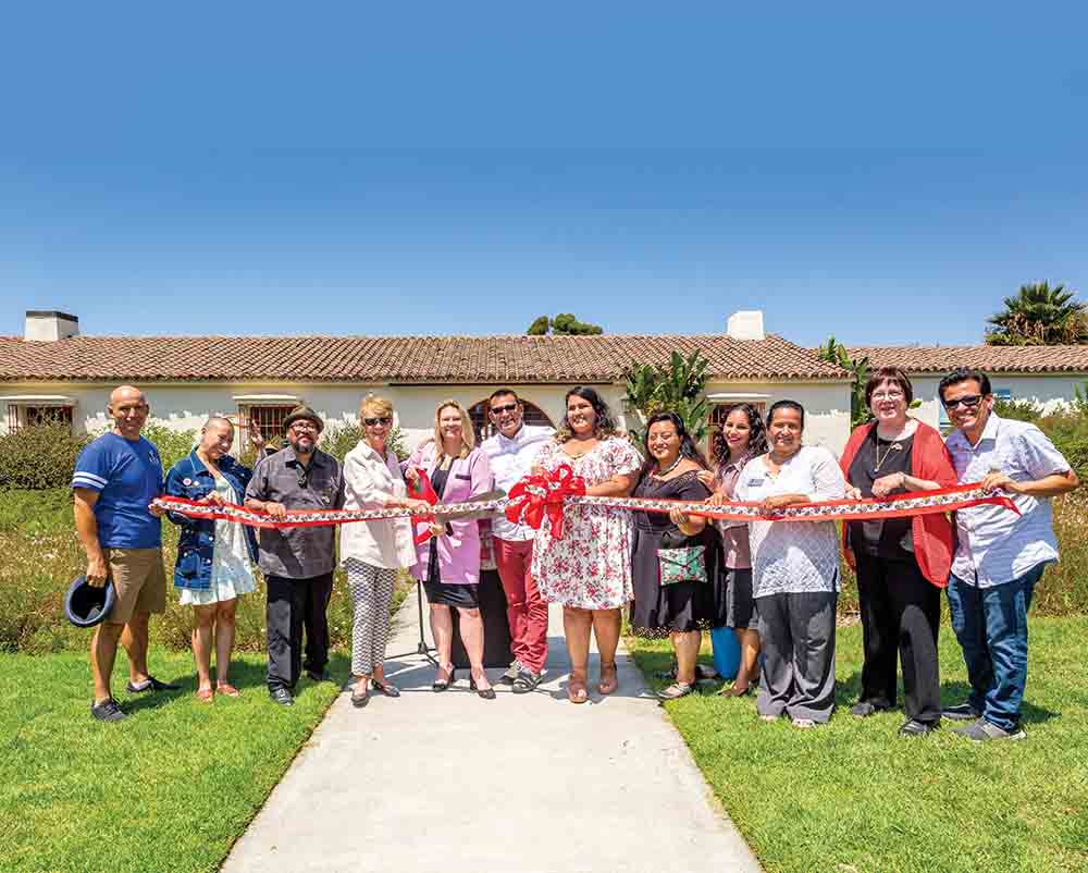 In 2019, President Erika Beck cuts the ribbon for the Michele Serros Collection located in Richard R. Rush Hall.