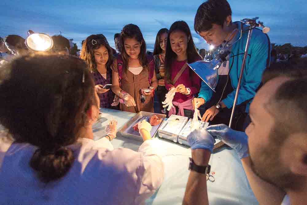 Student volunteers show off a Biology experiment to curious onlookers at CSUCI’s Science Carnival.