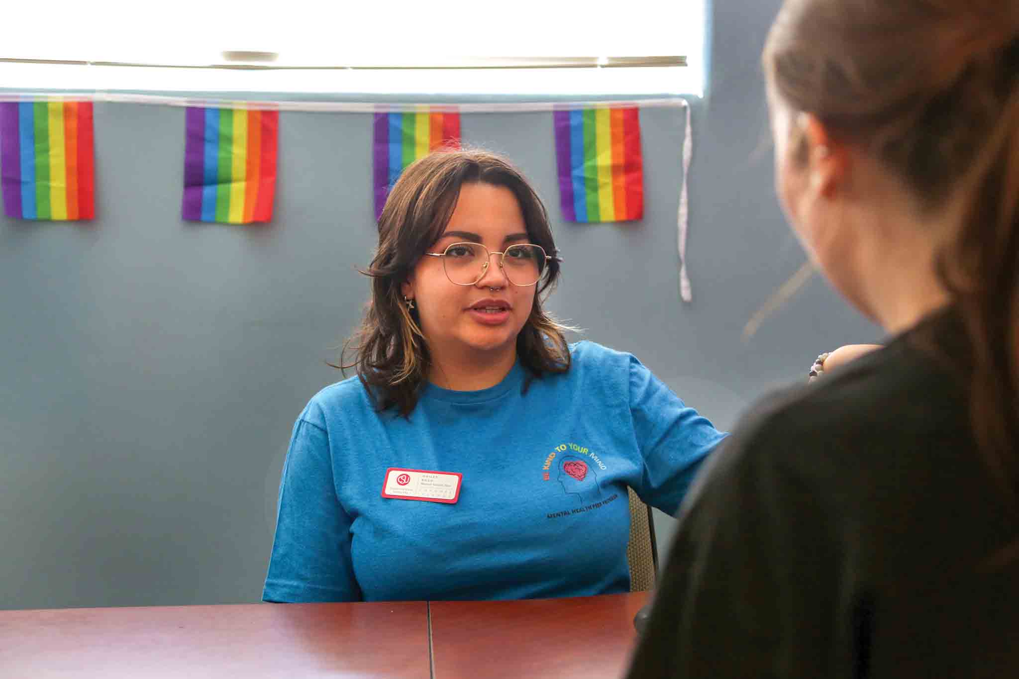 A Psychology student and Mental Health Peer Hailey Razo speaks with a student.