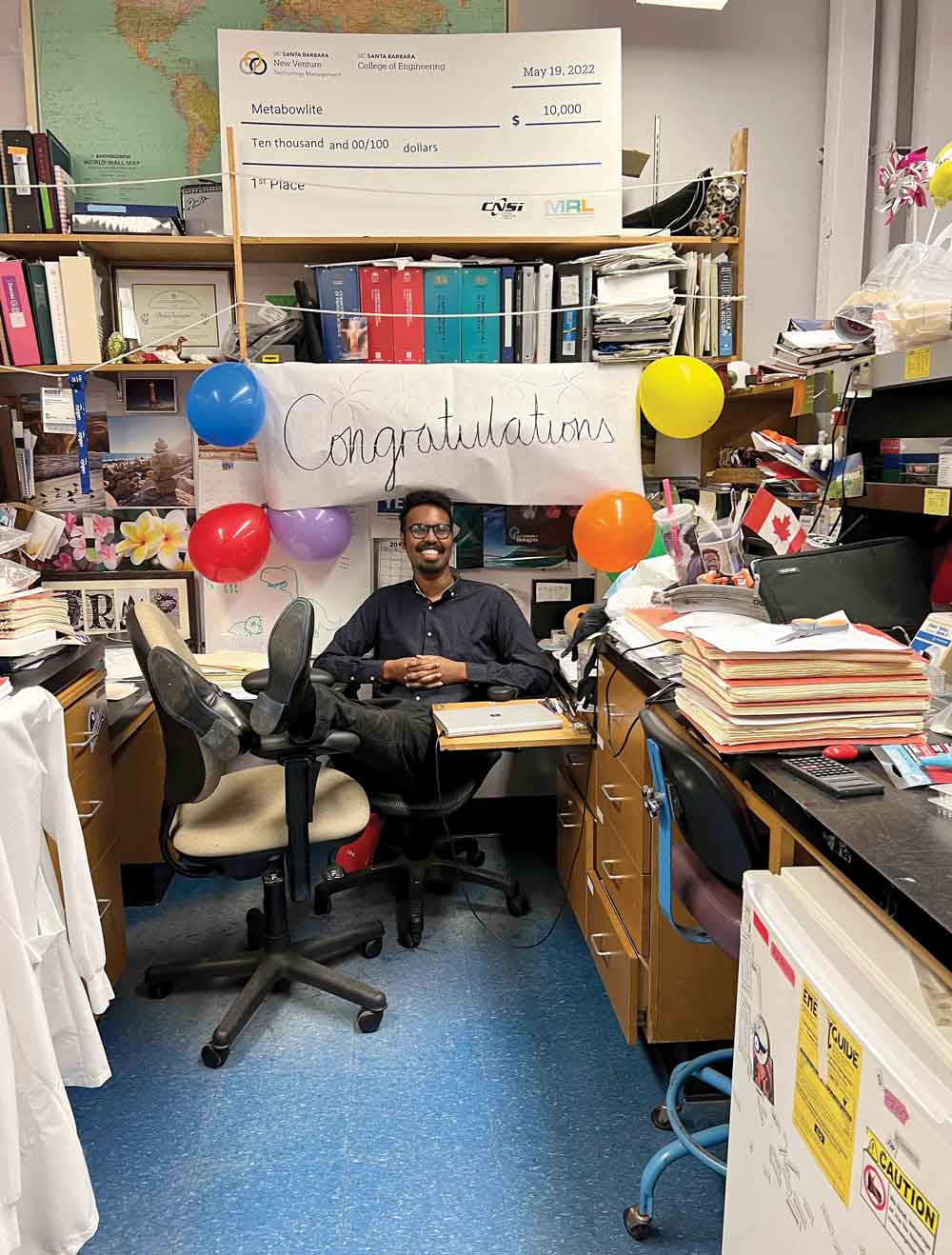 Mohamed Faynus in his office after coworkers decorated it to congratulate him on his Ph.D.