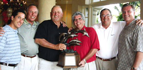 Six gentlemen holding a dolphin trophy