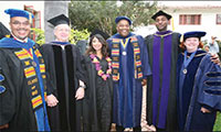 faculty and staff posing together at commencement