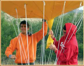 student Kosta Grammatis holds his balloon project as it is ready for launch