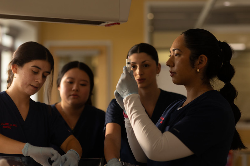 4 nursing students gathered conducting medical tasks