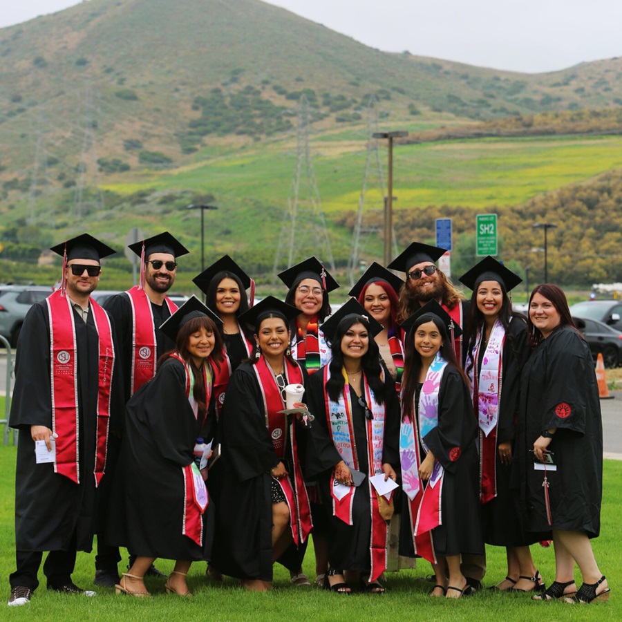 students smile for a group photo at CSUCI commencement