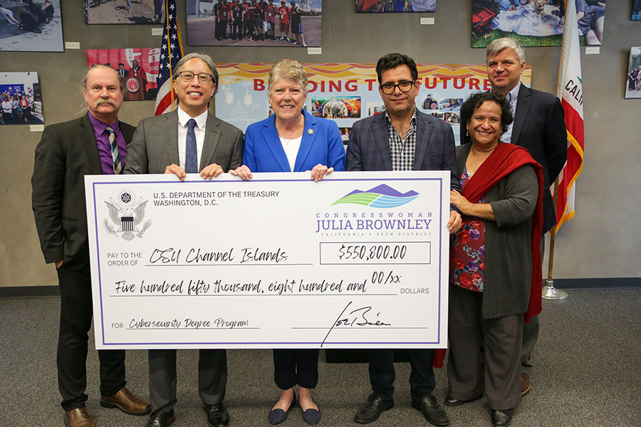 U.S. Representative Julia Brownley poses with CSUCI President Richard Yao, Provost Mitch Avila, and three others while holding a check for $550,800 to be used to fund a new Bachelor of Science in Cybersecurity program