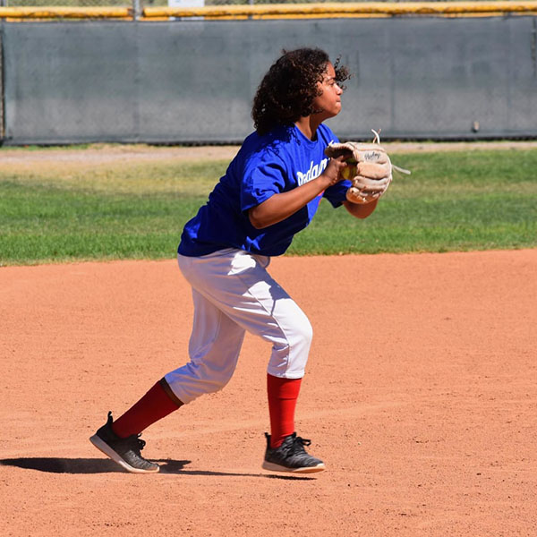 A camper fields a ball.