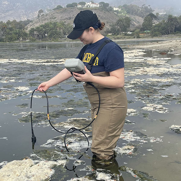 A student monitors water quality for a research project.