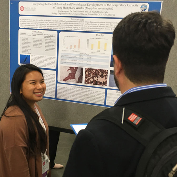 A student shares her research poster.
