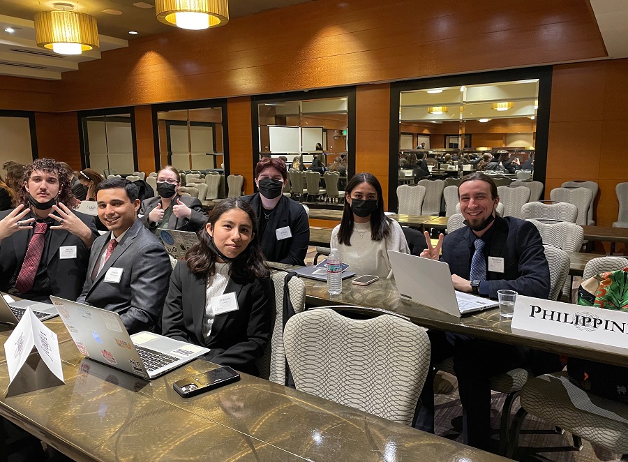 Model UN students sit together at a table at the delegate assembly gathering in Seattle