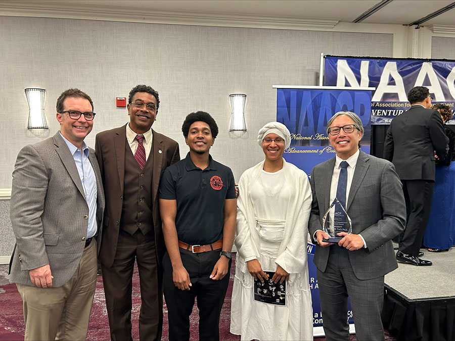 President Richard Yao stands with the award and other members of Ventura County NAACP and CSUCI