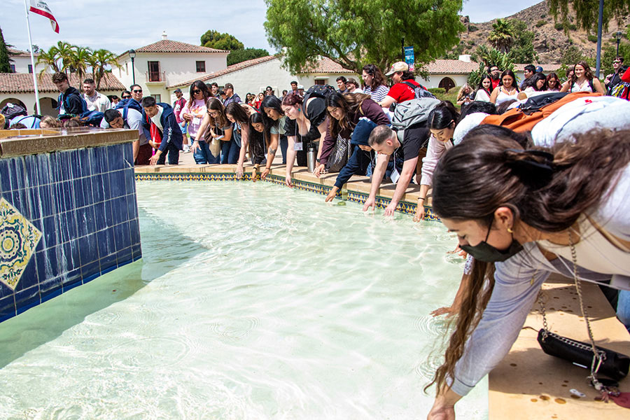 Students touch the water in the fountain during Transfer Orientation, a tradition that marks the beginning and ending of a CSUCI undergraduate education.