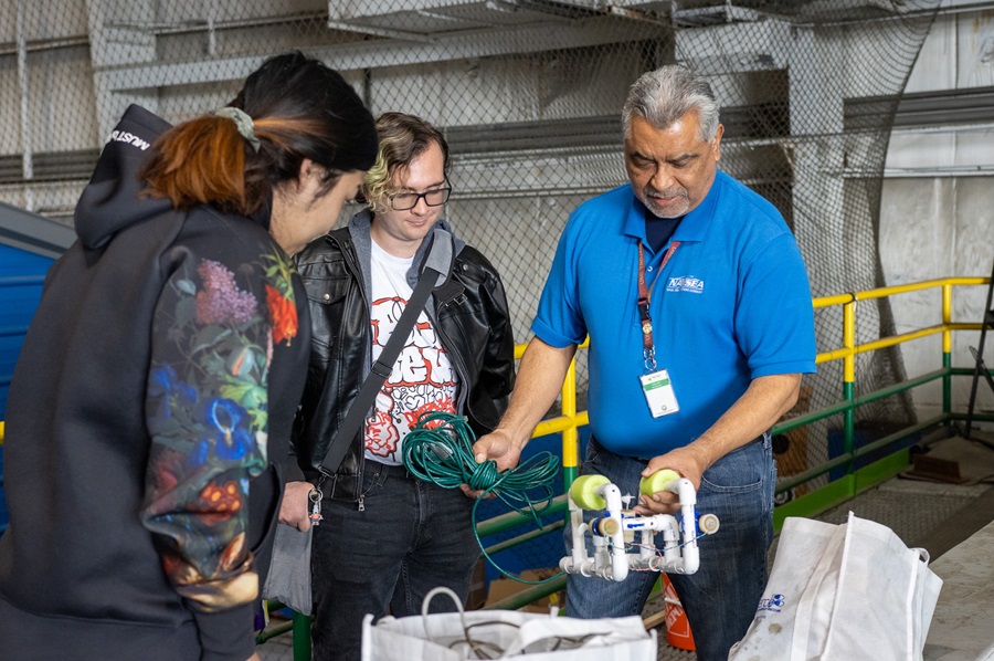 Dr. Ramon Flores works with students during the Sea Perch program