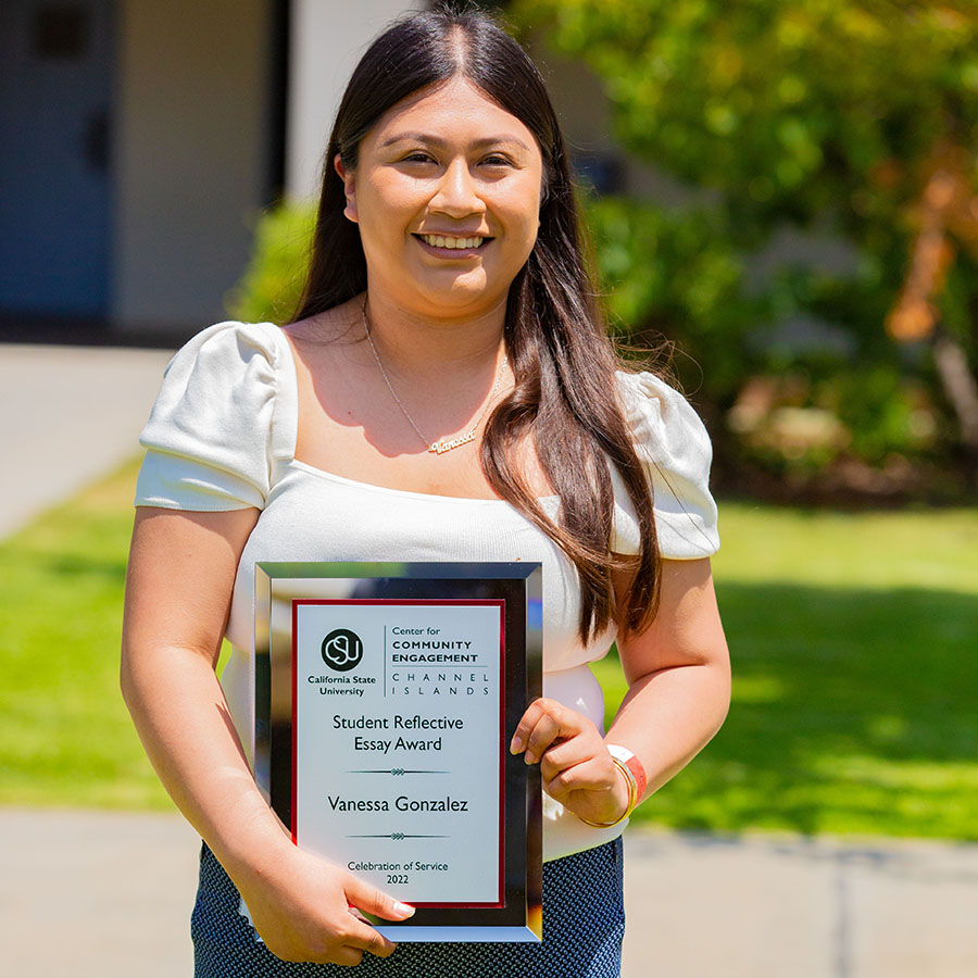 Vanessa Gonzalez holding her 2022 Student Reflective Essay Award.