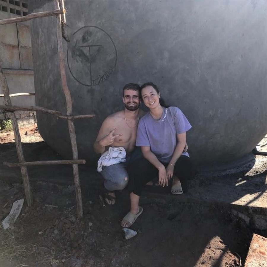 Alyson Lucas and her business partner sit in front of a new well in Madagascar