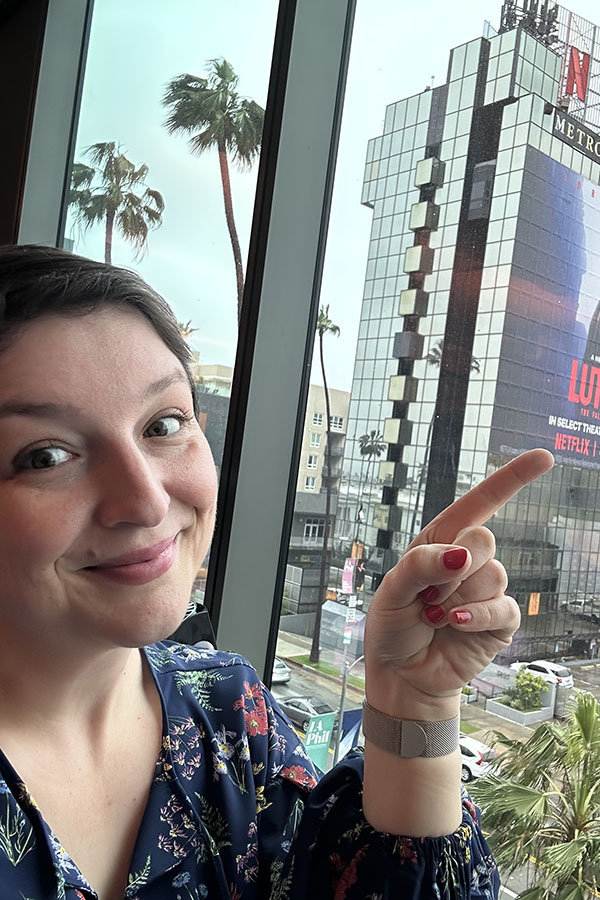 Christina Thiele-Yancy points to a Netflix building sign.