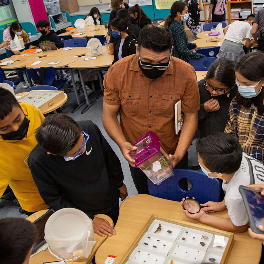 Professor Ruben Alarcon, with young students from Oxnard, examines edible bugs