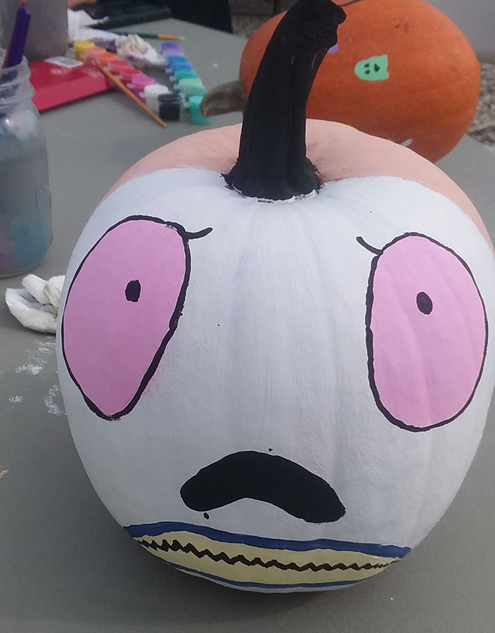 pumpkin painted with sad/shocked face