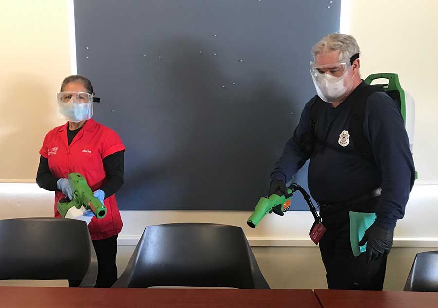 Custodians cleaning campus offices.