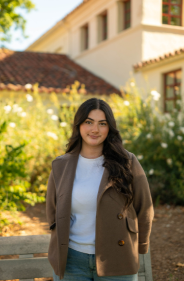 a student standing in a CSUCI courtyard looking at the camera