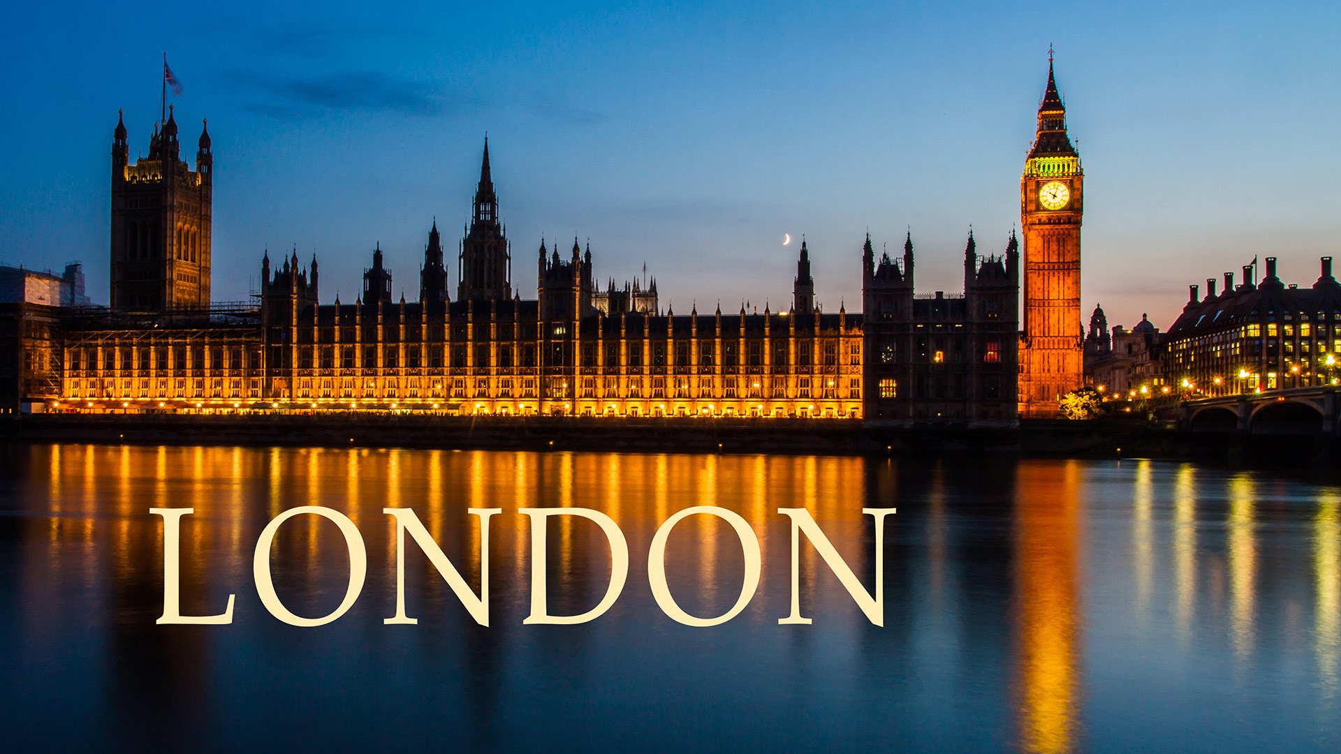 Background is the London skyline at night. in the foreground is white lettering is the word london