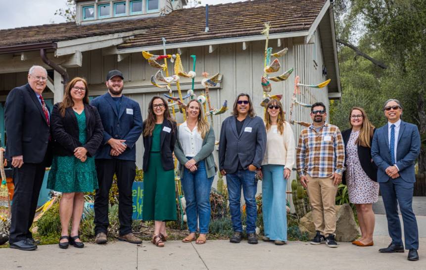 Group of staff and faculty at the Santa Barbara Zoo in front of the marine debris art exhibit made my CI students.