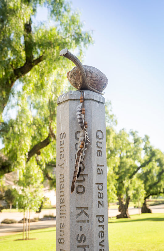 Photo of abalone shell resting atop the campus Peace Pole