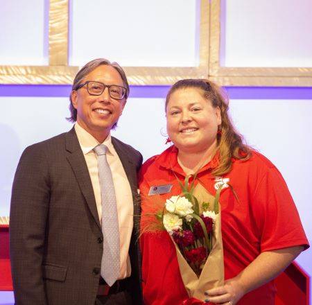 president and tanya smiling on stage together