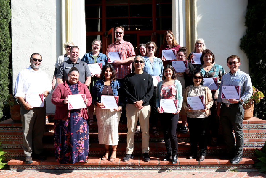 POEC Inaugural Cohort poses for photo with President Yao and their certificates.