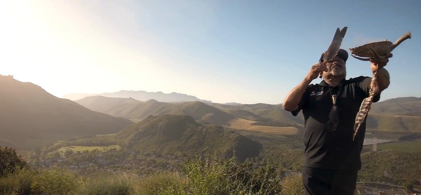 Raudel Banuelos performing a blessing at the top of a mountain