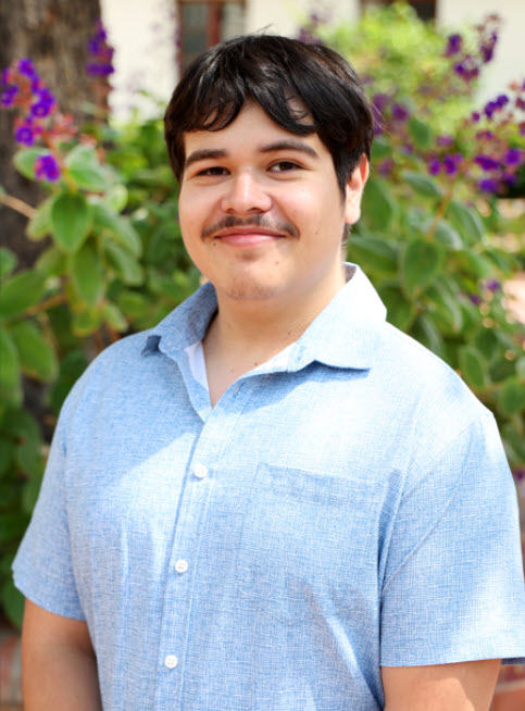 photo of hector standing outside smiling