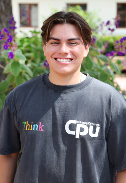 photo of soren standing outside smiling