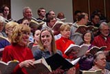 Choir members and conductor in practice