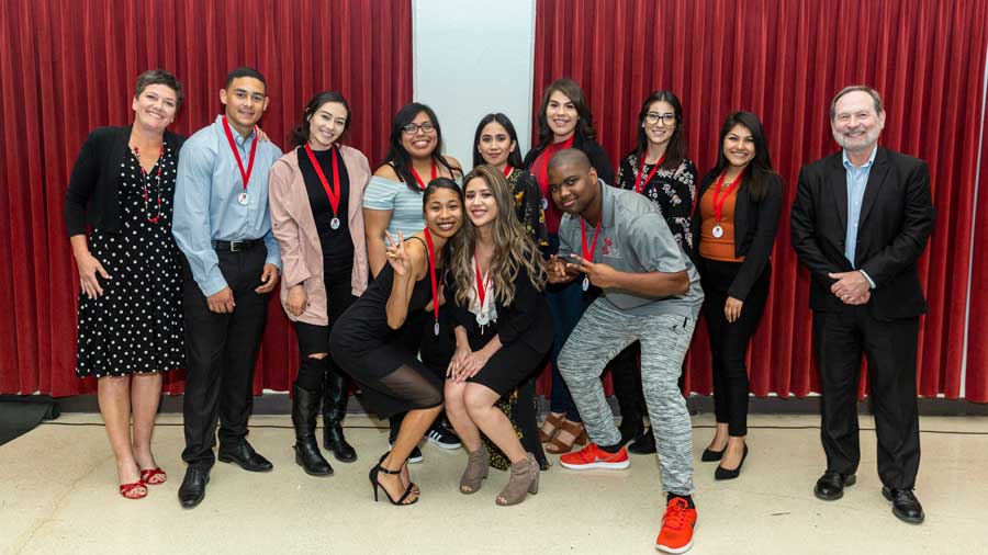 students and faculty in a group photo for the 2018 grad class