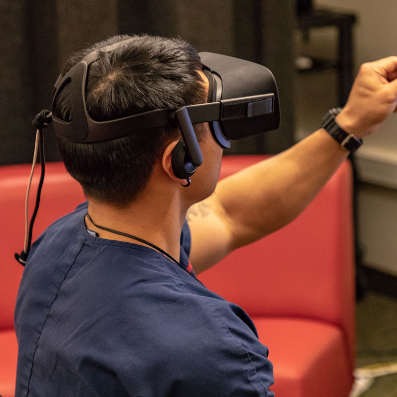 A male student wearing a virtual reality headset