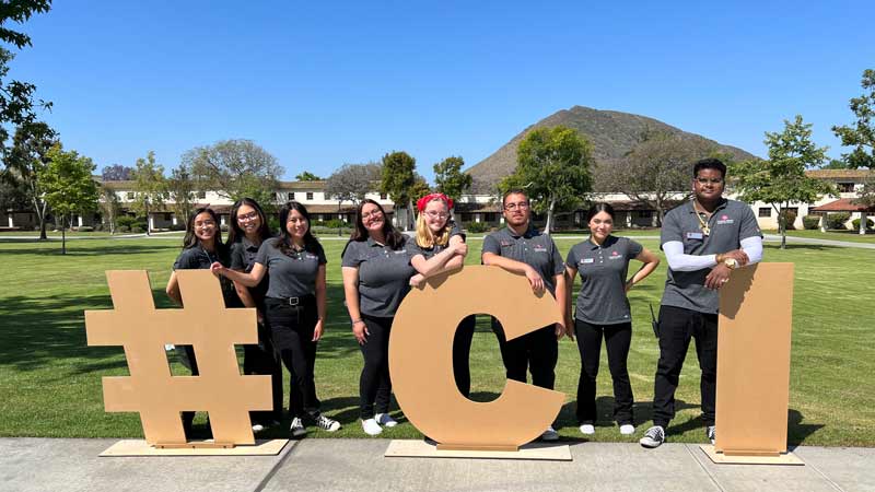 Student Ambassadors with wooden letters