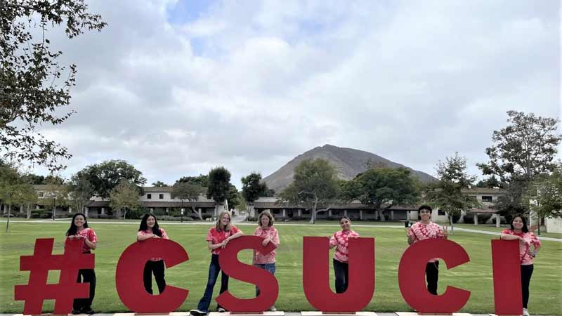 Student Ambassadors with wooden letters