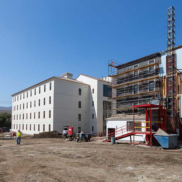 Dorm construction site with a building in the process of being complete